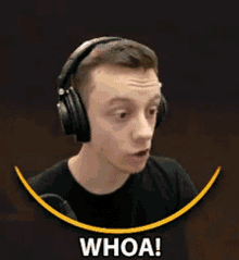 a man wearing headphones is making a surprised face and says whoa !