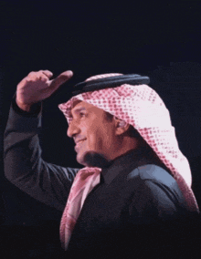 a man in a turban is standing in front of a glowing object