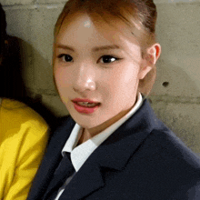 a close up of a woman wearing a suit