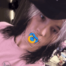 a person wearing a pink shirt has a pacifier in their mouth