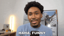 a man says " haha funny " in front of a poster