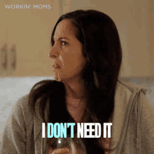 a woman is holding a glass of water and says i don t need it