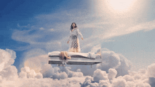 a woman standing on a bed in the sky