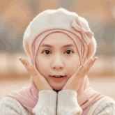 a woman wearing a hijab and a beret has her mouth open and the word wow is on the bottom