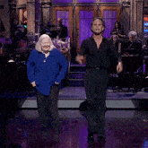 a man and a woman are dancing on a stage with a sign that says ncnorell on it
