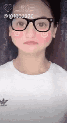 a girl wearing glasses and a white shirt with the word adidas on the front