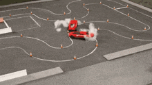 two toy cars are racing on a track with smoke coming out of the tires