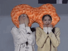a girl wearing a shirt that says est.2019 stands next to another girl wearing a donut hat