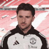a man wearing a manchester united jersey with the number 7 on it