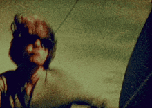 a close up of a person 's face with a blurred image
