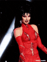a woman in a red dress and gloves is dancing on a stage with the words t4yce tumblr below her