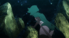 a girl in a green hooded cape is standing in a cave