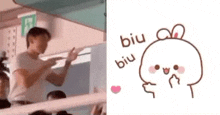 a man is standing in front of a crowd of people and a cartoon of a rabbit with a heart on its face .