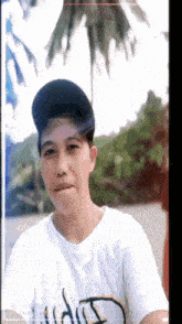 a man wearing a hat and a white shirt that says ' aida ' on it
