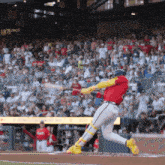 a baseball player swings a bat at a ball in front of a scoreboard that says 1871 on it