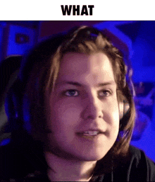 a man wearing headphones is making a funny face while sitting in a chair .