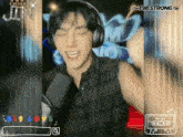 a man wearing headphones is singing into a microphone and the words big love are on the bottom