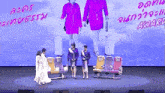 a group of women are standing on a stage in front of a screen that says ' award '