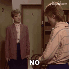 a woman in a pink jacket says no while standing next to another woman in a pink jacket