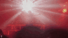 a blurred image of a stage with the letter d on the bottom right