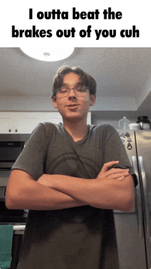 a young man with his arms crossed stands in front of a refrigerator that says i outta beat
