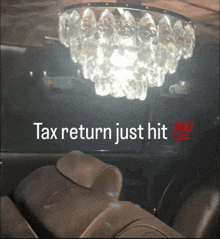 a car with a chandelier hanging from the ceiling and the words tax return just hit 100
