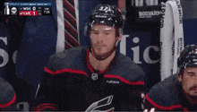 a hockey player with the number 33 on his helmet stands in the stands