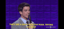 a man stands in front of a microphone and says they see a 28yo healthy man
