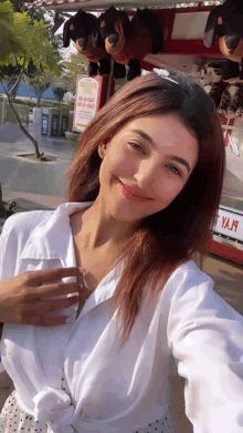 a woman taking a selfie in front of a sign that says ya19
