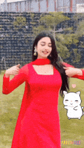 a woman in a red dress is dancing in front of a wall with the word moon on it