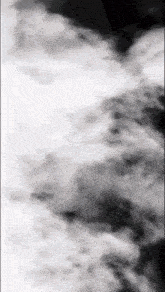 a black and white photo of smoke coming out of a bottle
