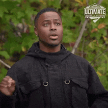 a man is wearing a black jacket with a canada 's ultimate challenge logo on the front