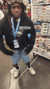 a man wearing a helmet and goggles is standing in front of a toy aisle with boxes of hot wheels cars