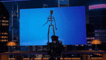 a person standing in front of a large screen that says turboshark