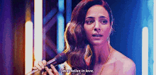 a woman is singing into a microphone and saying `` i 've fallen in love '' .