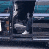 a person is sitting in the back seat of a van