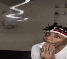 a man wearing a headband with the word ohio on it looks at something