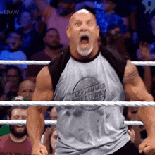 a man in a wrestling ring wearing a shirt that says " rock hammer speedway "