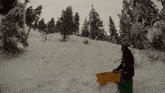 a person sledding down a snow covered hill