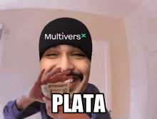 a man wearing a beanie with the word multivers on it is holding a bunch of money