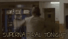 a man is dancing in a room with the words supernatural tonight written in the corner