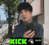 a man taking a picture of himself with the word kick on the bottom right