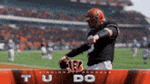 a cincinnati bengals football player throws a ball