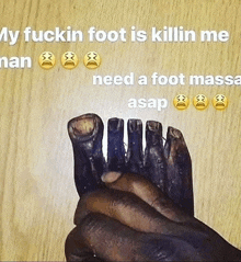 a person is holding a pair of feet with a caption that says my fuckin foot is killin me