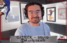 a man wearing headphones and glasses is gazrick druid