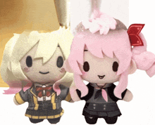 two stuffed dolls with blonde hair and pink hair