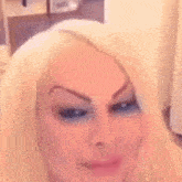 a close up of a woman 's face with blonde hair .