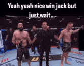 two men are standing next to each other in a boxing ring with a referee .