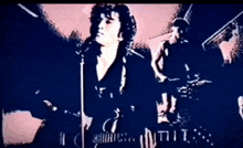 a man is singing into a microphone in front of a band