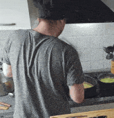 a man wearing a chef 's hat is cooking in the kitchen